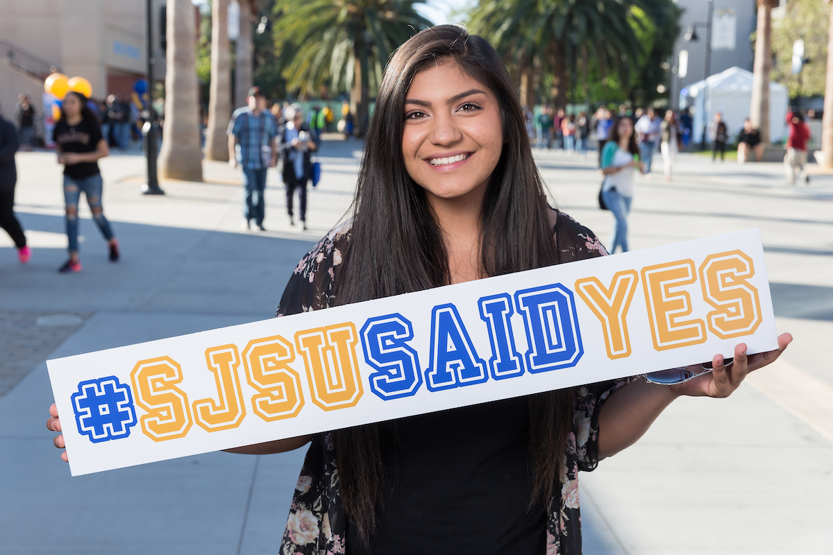 Student holding sign #SJSUsaidYes