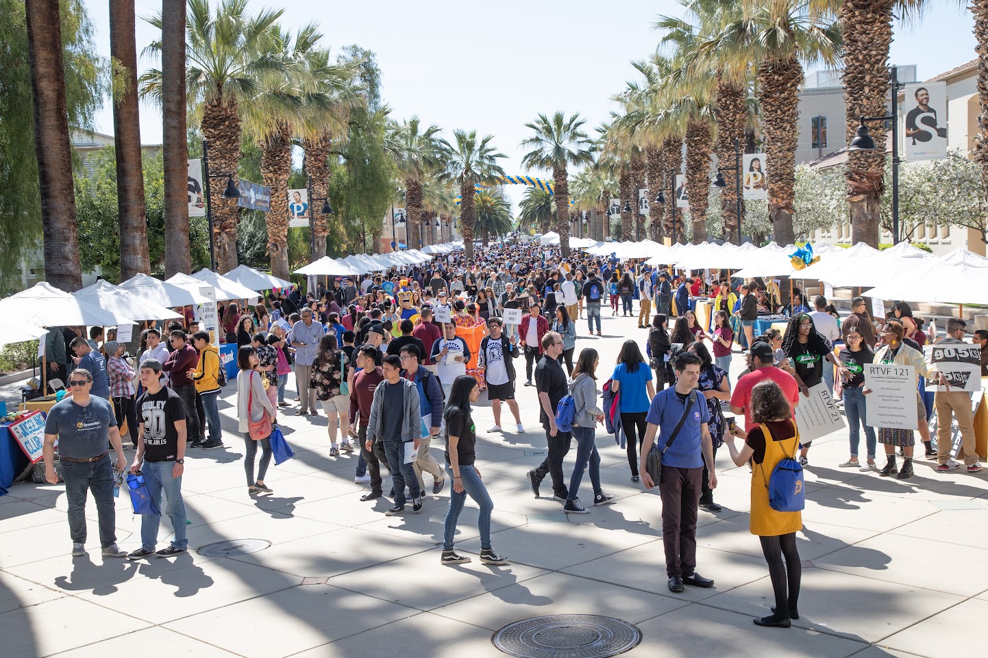 Hundreds of students walking around campus with booths and tables set up