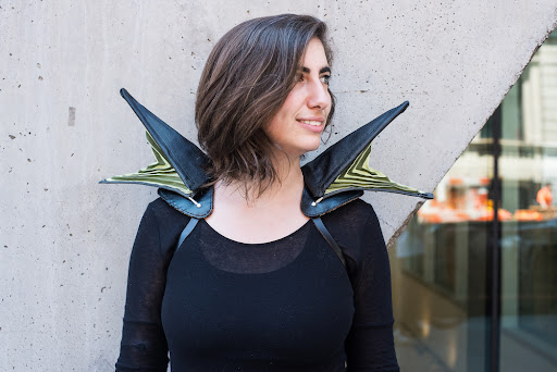 Photo of a woman wearing wing-like extrusions on her shoulders