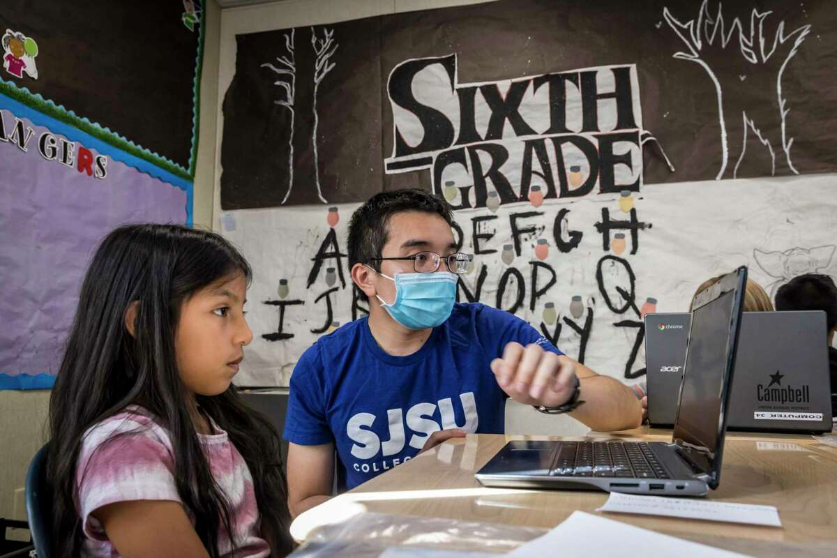 Our Fellow, William Ngo teaching a student about Computer Science.