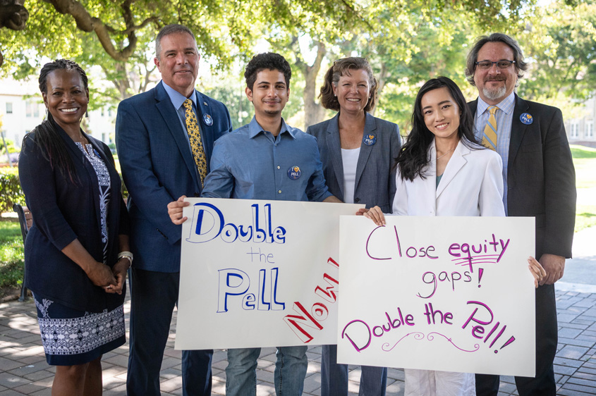 SJSU community members holding poster signs to Double the Pell.