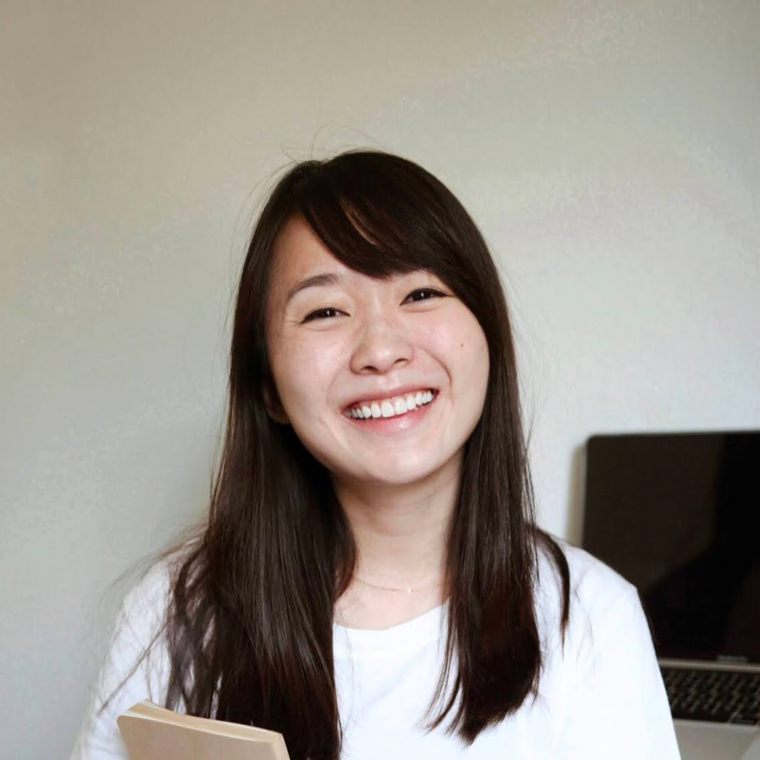 alice smiling holding a notebook