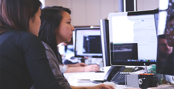 student behind a computer screen