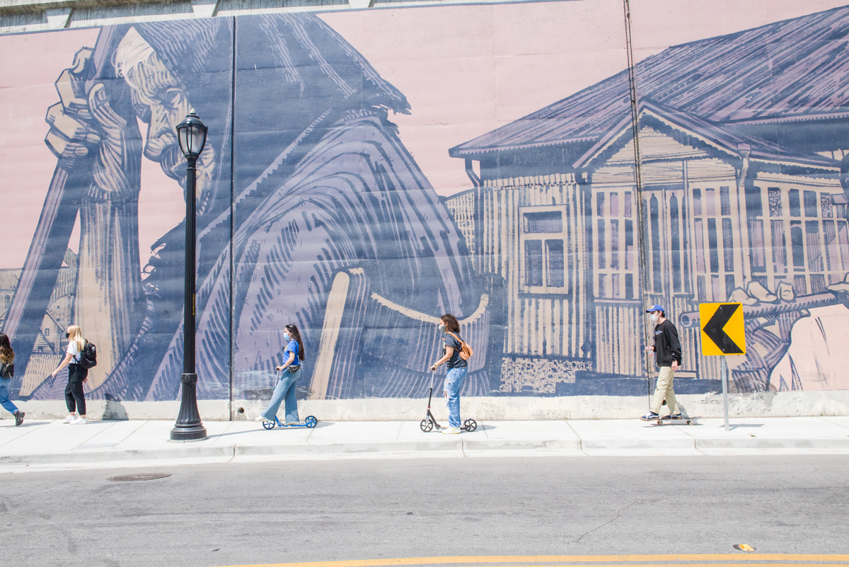 students in front of mural