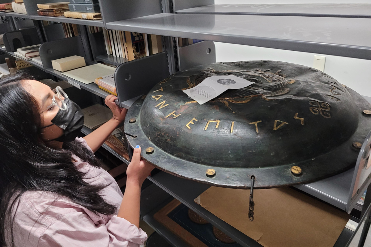 a student looking at an artifact.