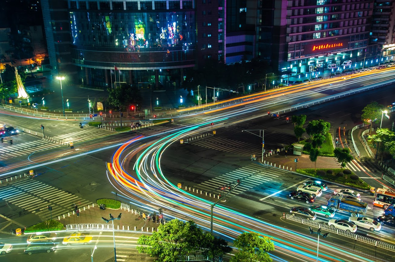 A long exposure photo of an urban street intersection in Guangzhou.