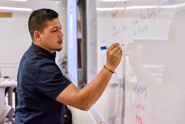 Professor writing on the whiteboard