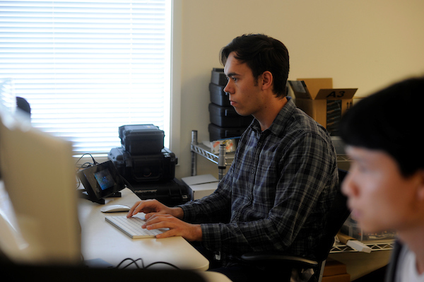 two students typing in a computer