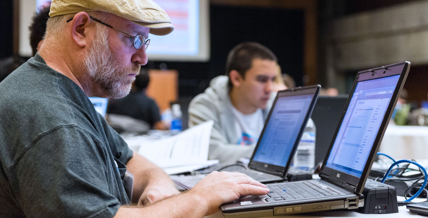 Cybersecurity student on laptop.