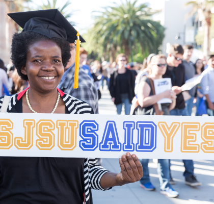 Student holding SJSU said yes banner