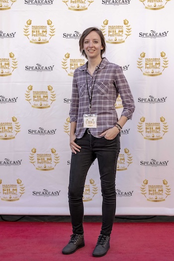 Ashley Seering in black jeans and a flannel shirt on the Red Carpet at the Passadena Film Festival.