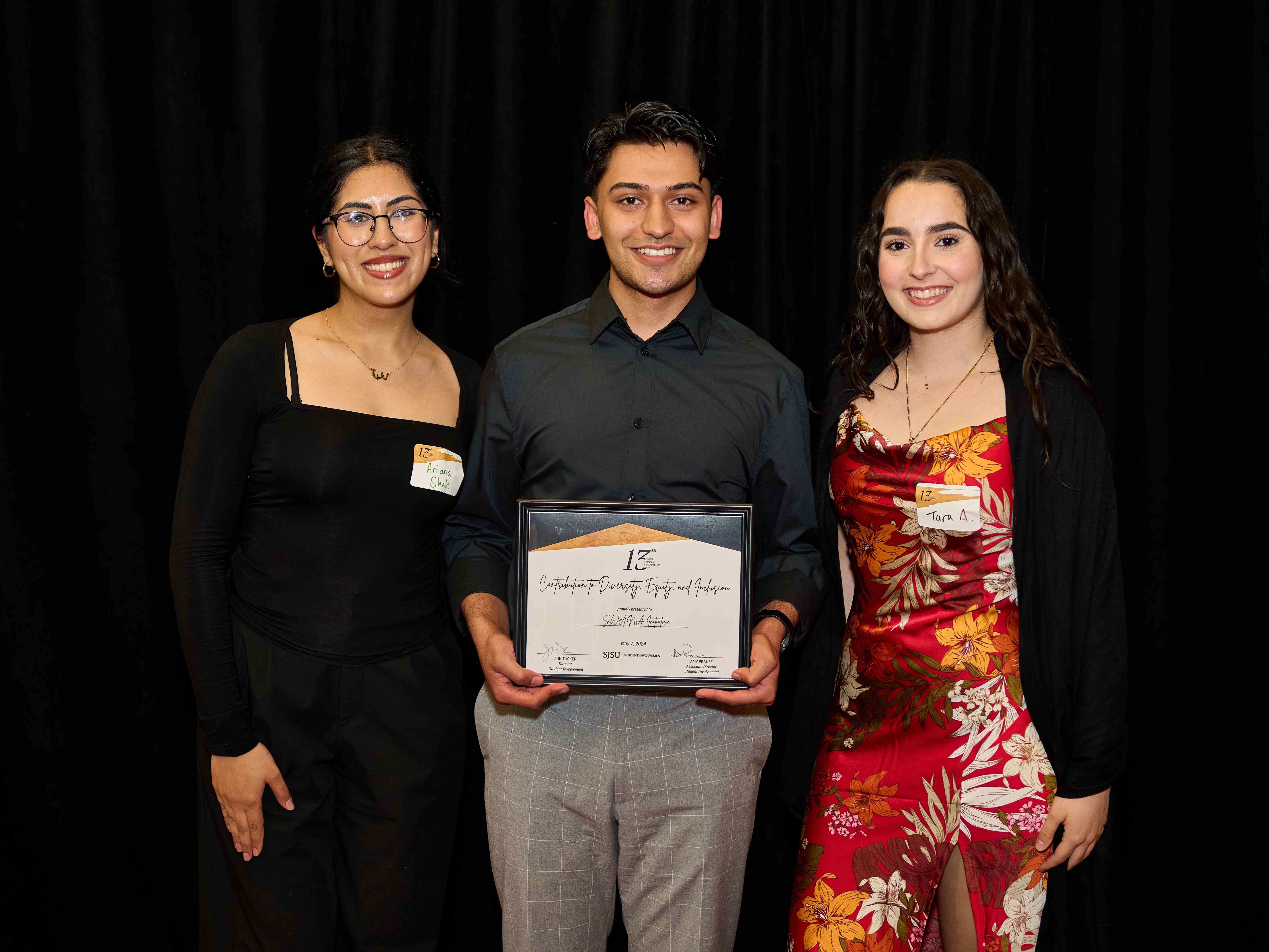 Students displaying award in front of backdrop at 2024 Leadership Gala