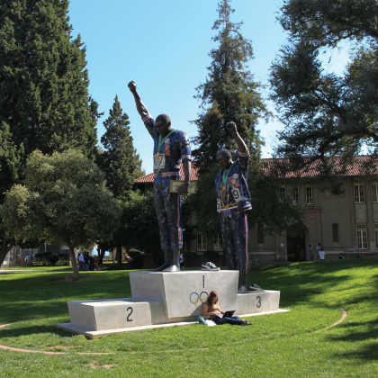 two men with fists raised statue.