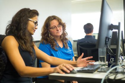 Student and advisor at a computer