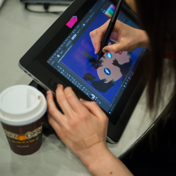 Student drawing on a tablet