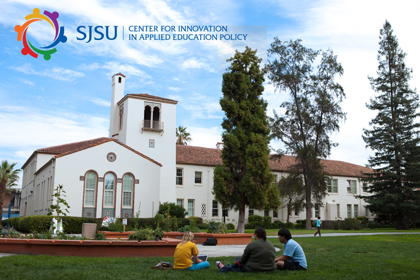 Students relaxing on the grass on campus