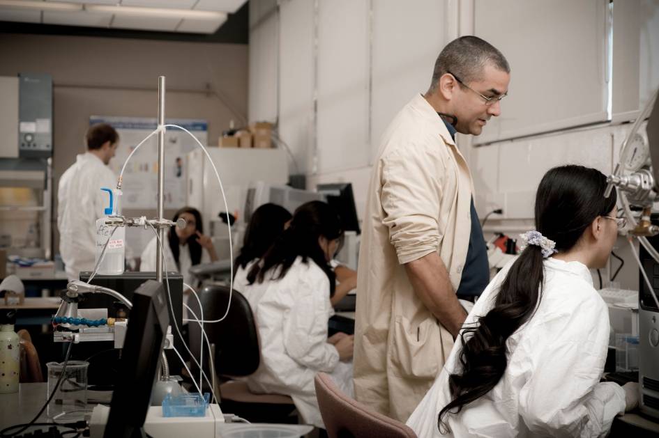 Professor and students working in a lab. 