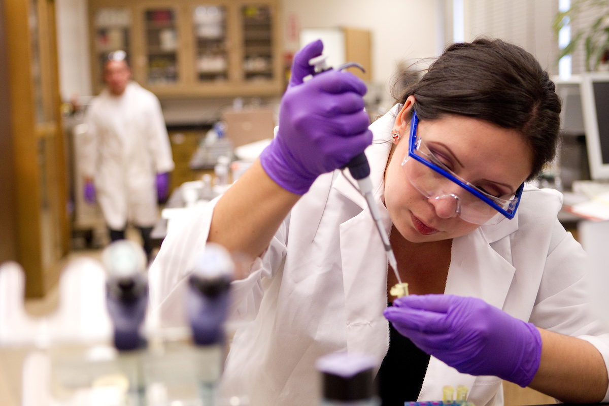 A researcher working with a needle and a tube. She'll get to the data stuff soon. 