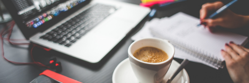 Image of a laptop and a cup of coffee.