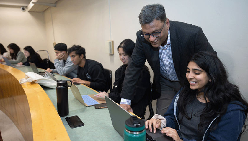 Nitin Aggarwal with his students from the AI in Business class. Photo by Jim Gensheimer.