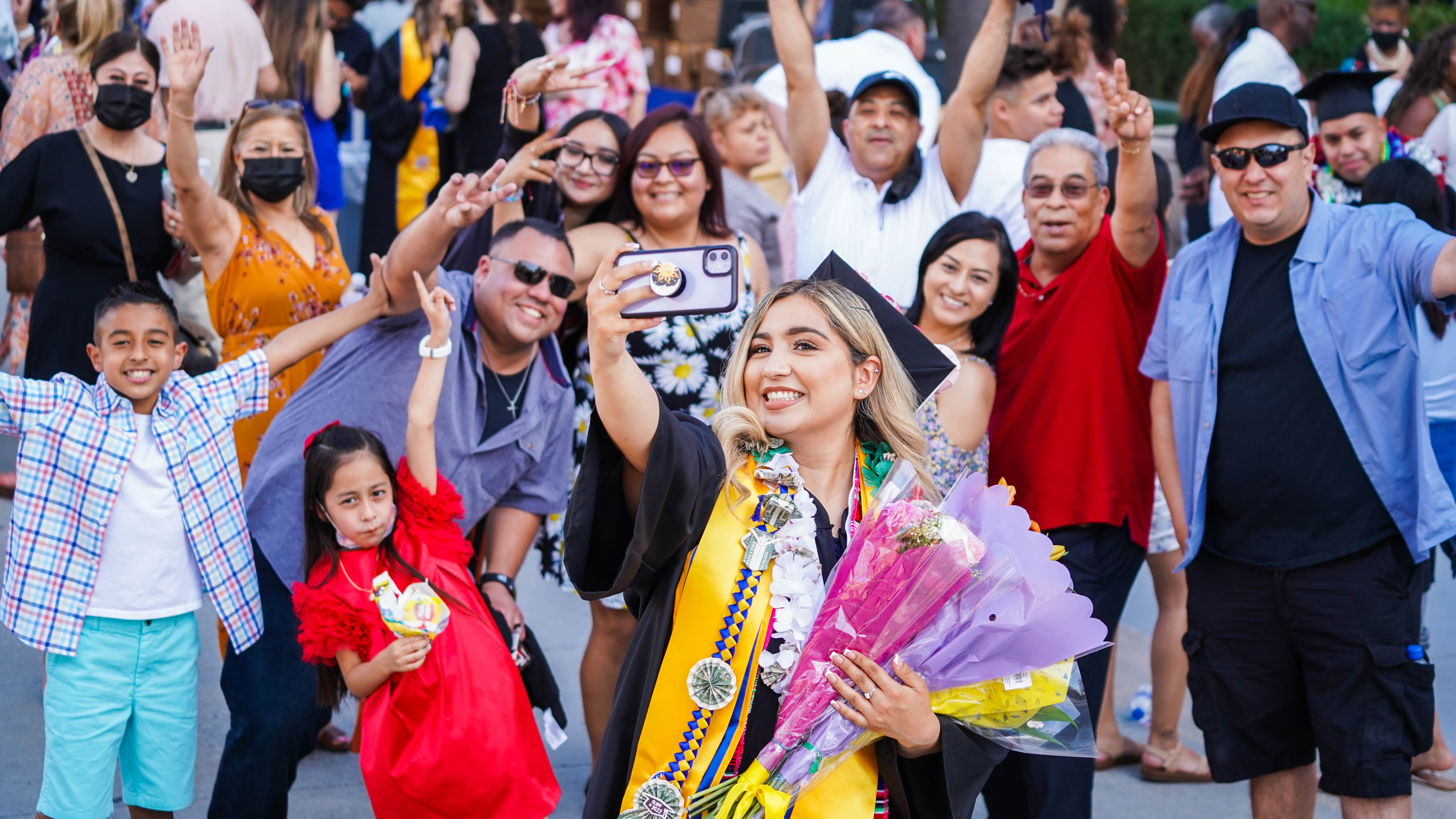 SJSU Female student taking a picture with family