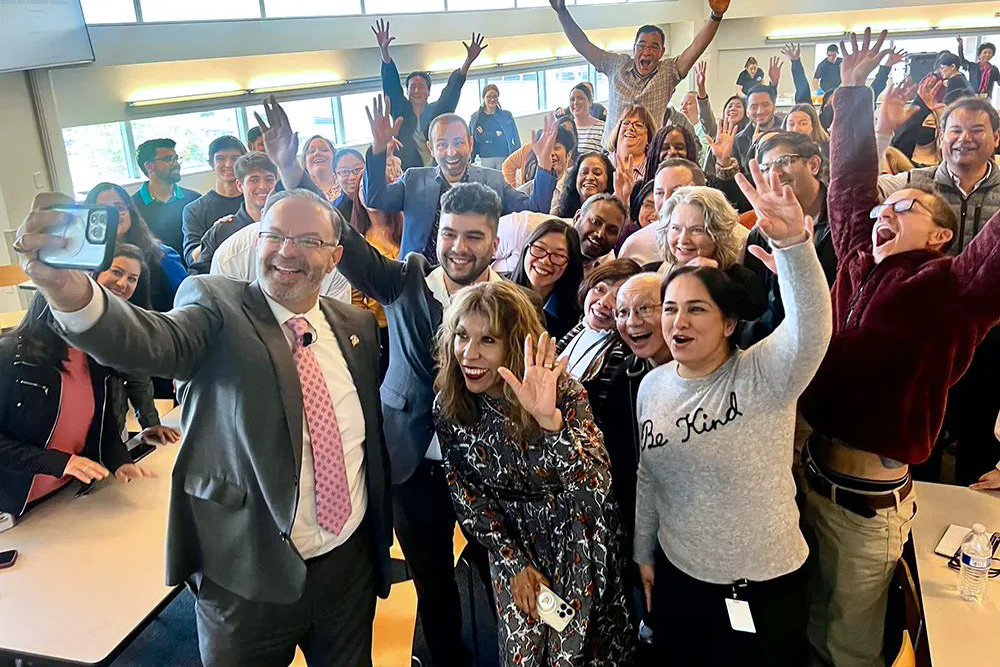 The president taking a selfie with the division of research and innovation.