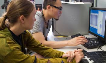 people work intently on computers