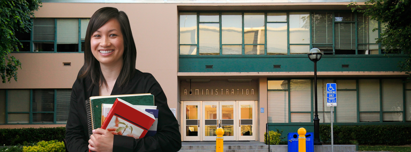 Student standing in front of Admin Building.