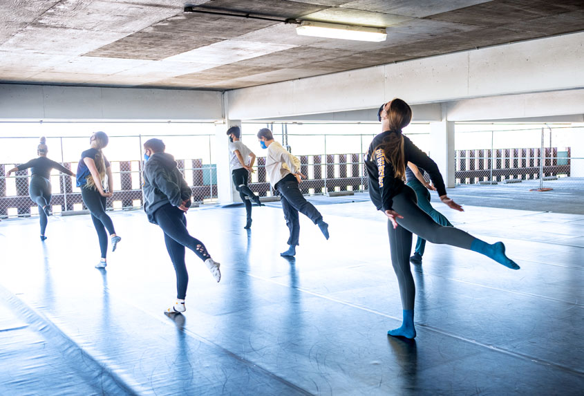 SJSU dancers mid-dance in the parking garage.