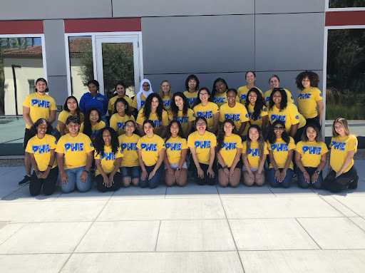 A group of Peer Health Educators in front of the Student Wellness Center